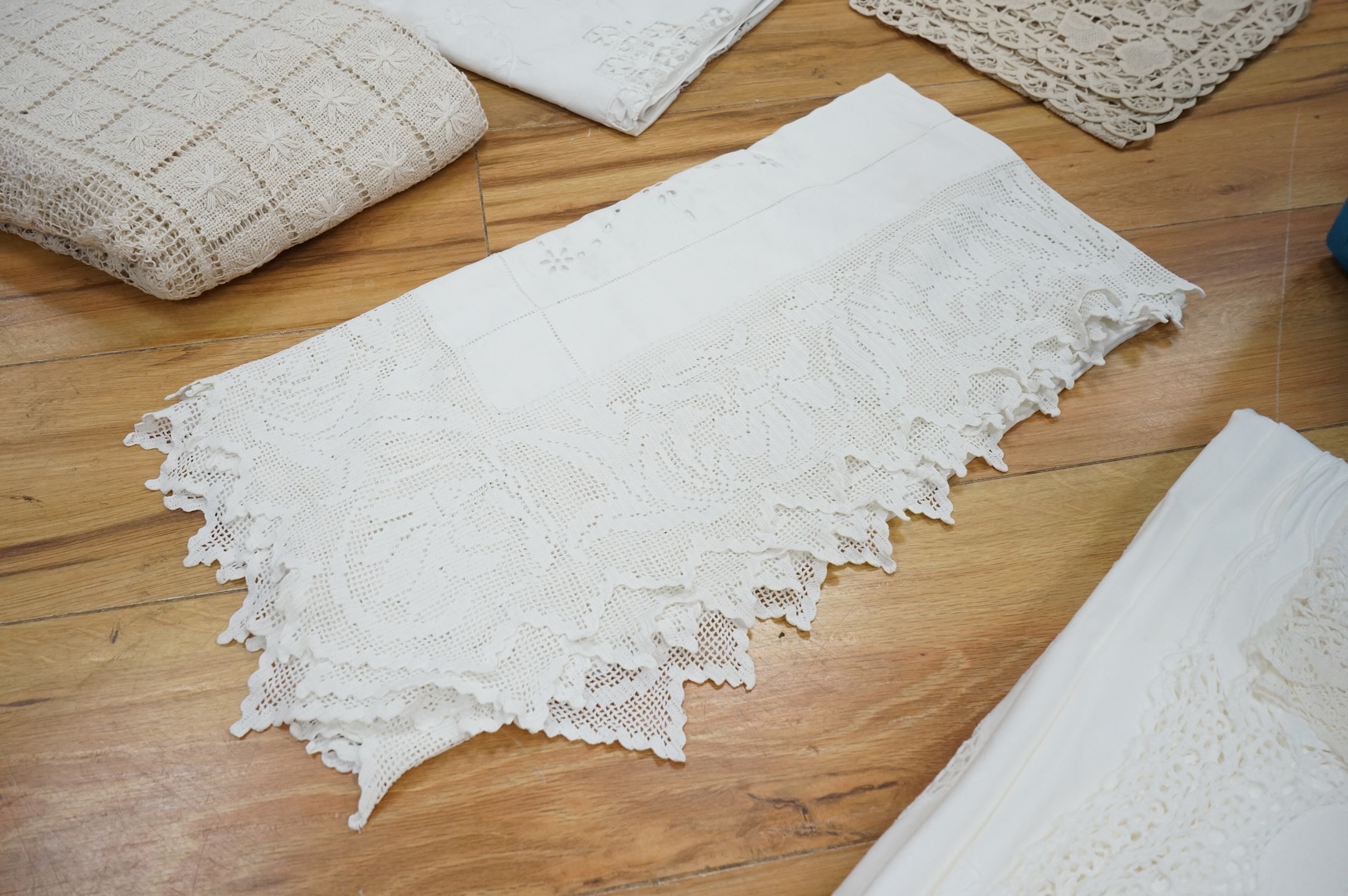 A collection of early 20th century and later crochet, cut work and drawn thread table linens and a large embroidered table cloth